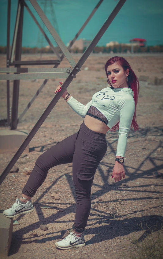 woman in white and red long sleeve shirt and black leggings holding black rifle