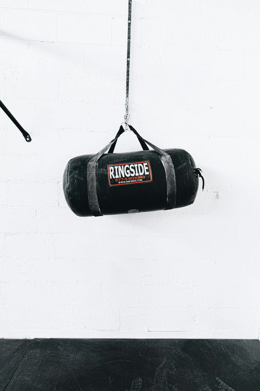 a boxing bag hanging from a rope in a gym