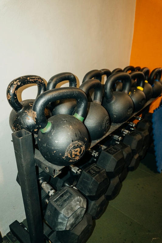 a row of kettles sitting on top of a rack