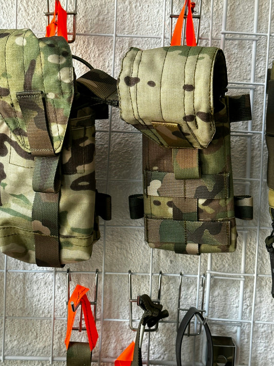 a couple of bags hanging from hooks on a wall