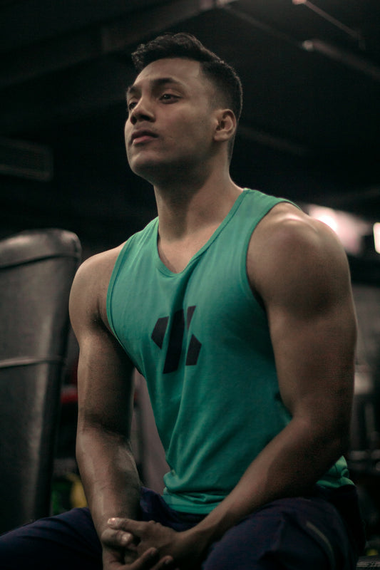 a man sitting on a bench in a gym