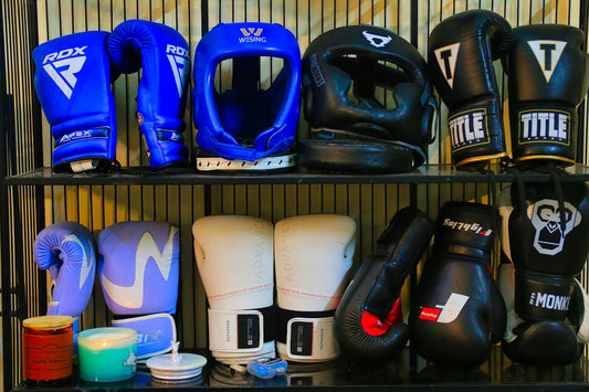 a shelf filled with lots of different types of boxing gloves