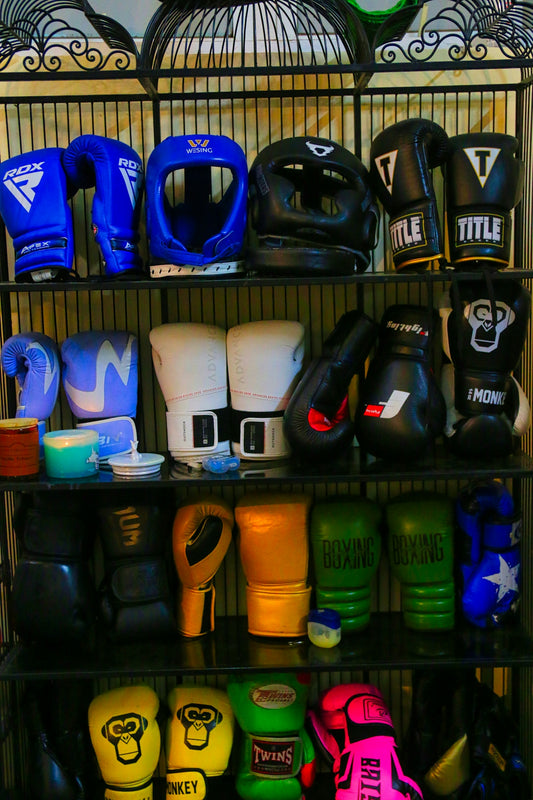 a rack filled with lots of different types of boxing gloves