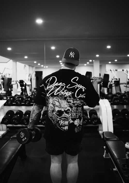 A man in a gym with a barbell