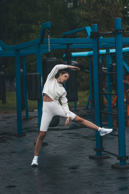 Woman stretching in an outdoor workout area.