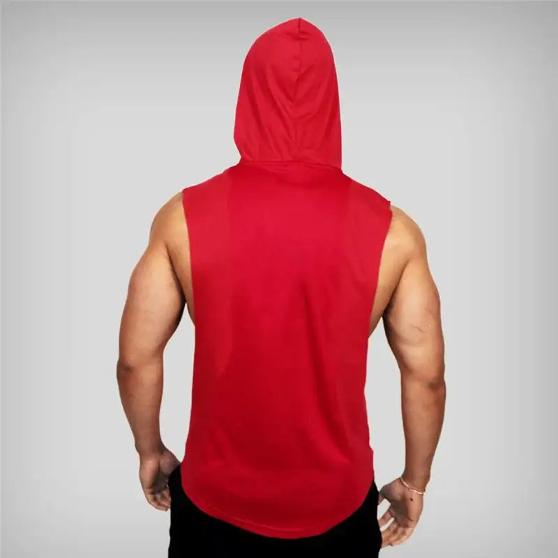 Muscular man wearing a sleeveless hooded gym shirt with 'NO PAIN NO GAIN' print, showcasing athletic style and workout motivation.