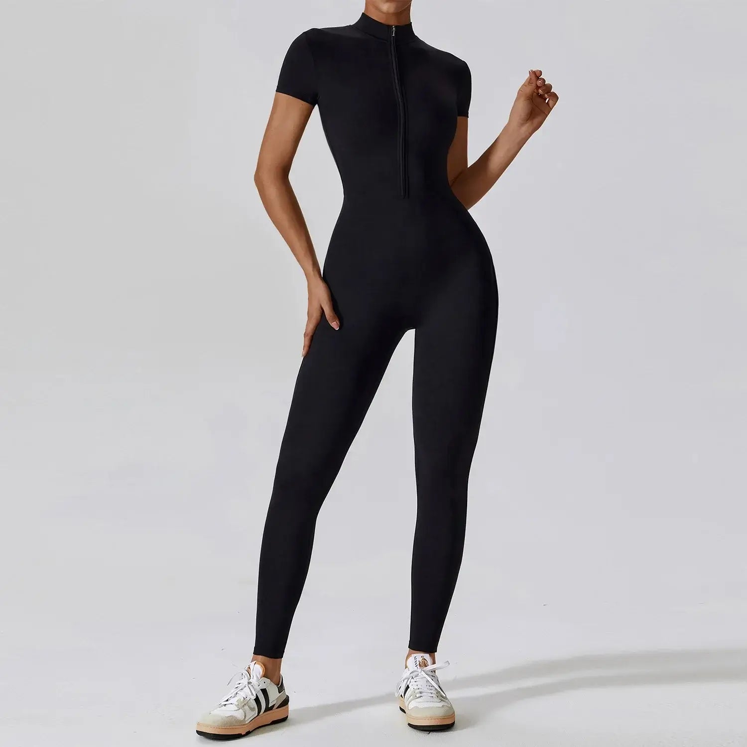 Womens tactical bodysuit in black, seamless zip-up design, perfect for high-performance workouts and stylish training.