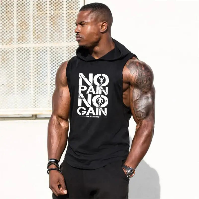 Muscular man wearing a sleeveless hooded gym shirt with 'NO PAIN NO GAIN' print, showcasing athletic style and workout motivation.